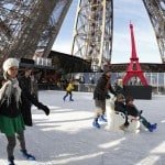 Tourists ice skate on the Eiffel Tower's skating rink in Paris